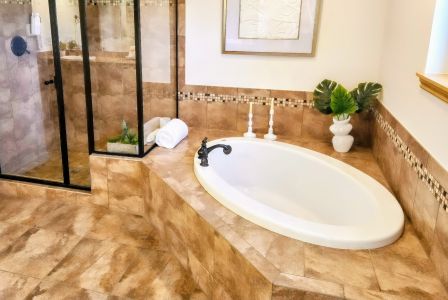 Spacious modern home interior in Bogotá featuring a minimalist white floating staircase and stylish decor.